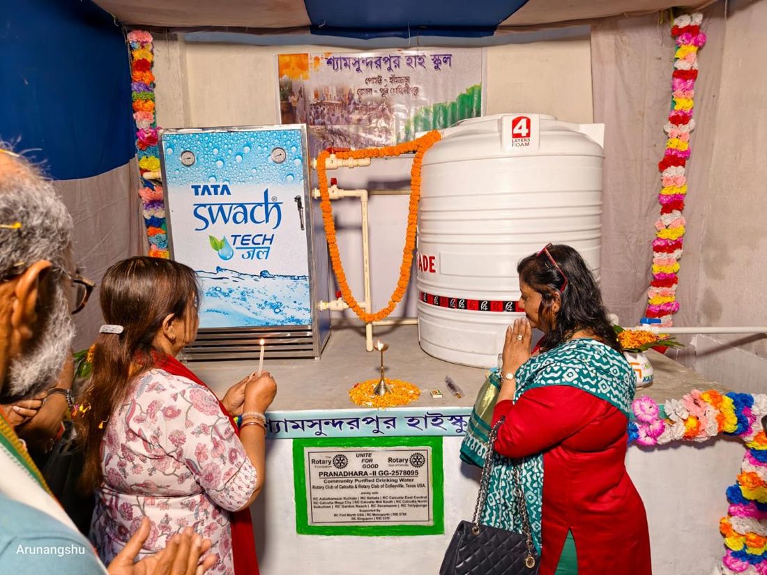 Rotarians light a lamp at the opening of a school drinking water plant built by the Rotary Clubs of Calcutta and Colleyville